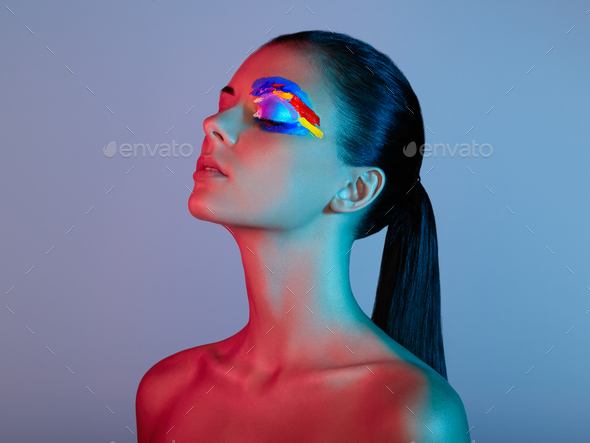 Fashion model woman with colored face painted - Stock Photo - Images