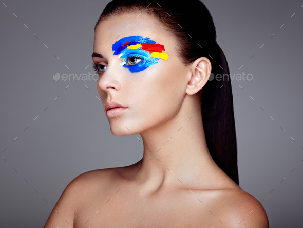 Fashion model woman with colored face painted - Stock Photo - Images