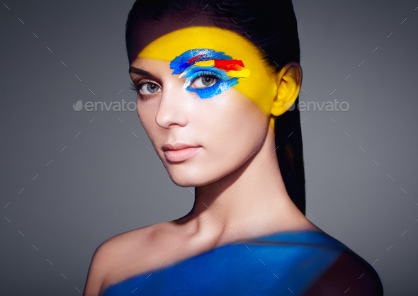 Fashion model woman with colored face painted - Stock Photo - Images