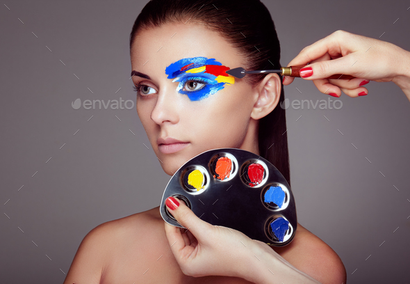 Makeup artist applies colorful makeup - Stock Photo - Images