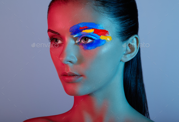 Fashion model woman with colored face painted - Stock Photo - Images