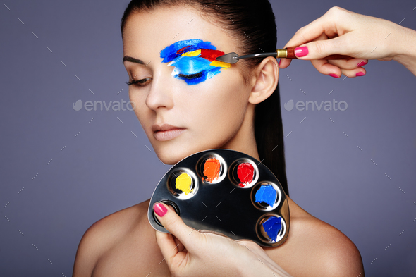 Makeup artist applies colorful makeup - Stock Photo - Images