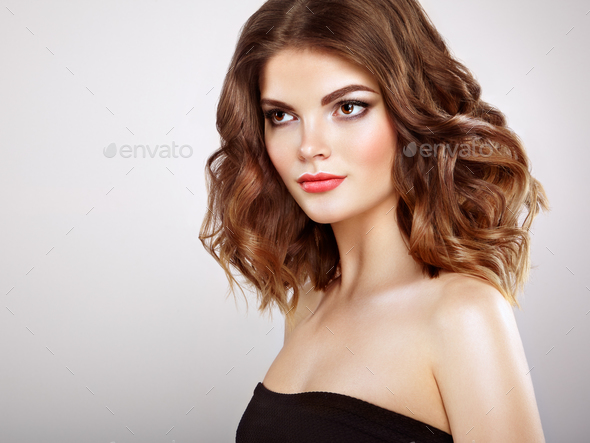 Brunette woman with long shiny wavy hair - Stock Photo - Images