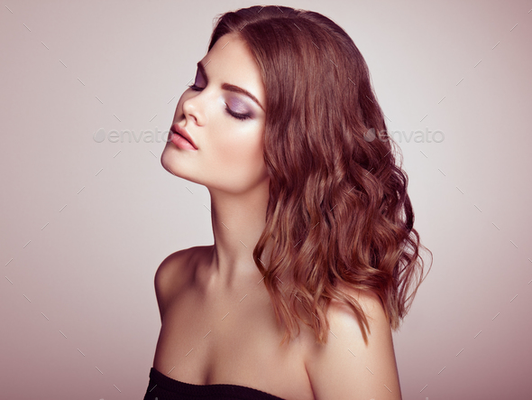 Brunette woman with long shiny wavy hair - Stock Photo - Images