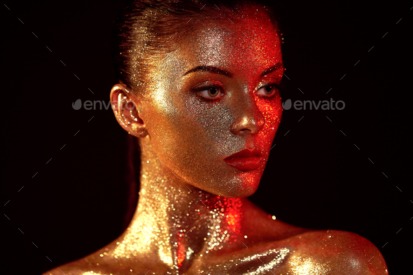 Portrait of beautiful woman with sparkles on her face - Stock Photo - Images