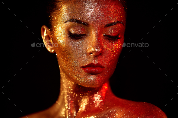 Portrait of beautiful woman with sparkles on her face - Stock Photo - Images
