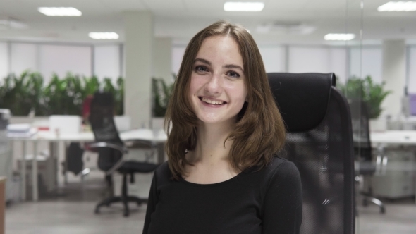 Young Happy Business Woman at Workplace in Office
