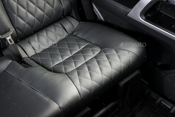 Black perforated leather back seats in modern luxury car Stock Photo by  gargantiopa