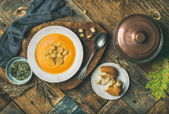Fall pumpkin cream soup with croutons and seeds - Stock Photo - Images
