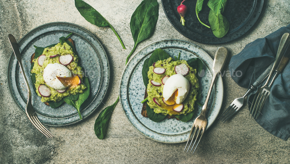 Healthy vegetarian breakfast flat-lay. Avocado and egg toasts, wide composition - Stock Photo - Images