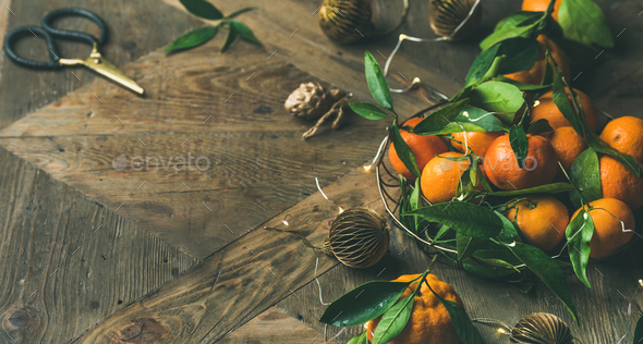 Fresh tangerines with leaves and decoration toys over wooden table - Stock Photo - Images
