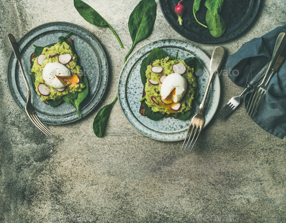 Healthy vegetarian breakfast flat-lay. Avocado and poached egg toasts - Stock Photo - Images