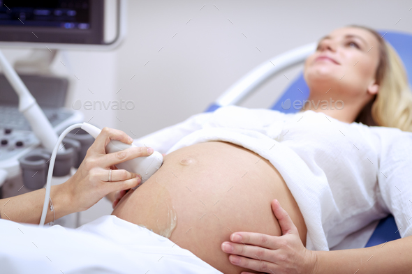 Pregnant woman on ultrasound - Stock Photo - Images
