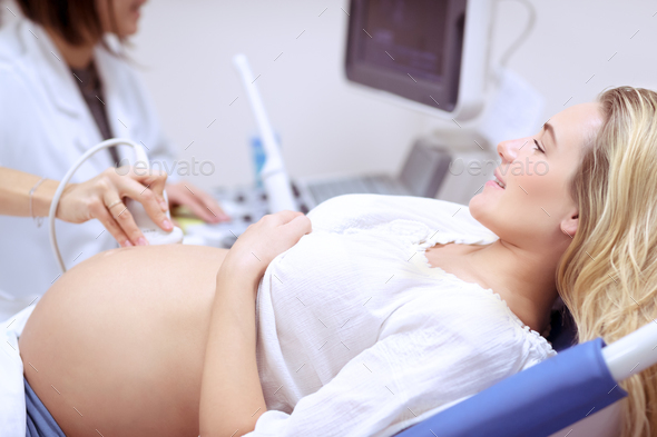 Pregnant female on ultrasound scan - Stock Photo - Images