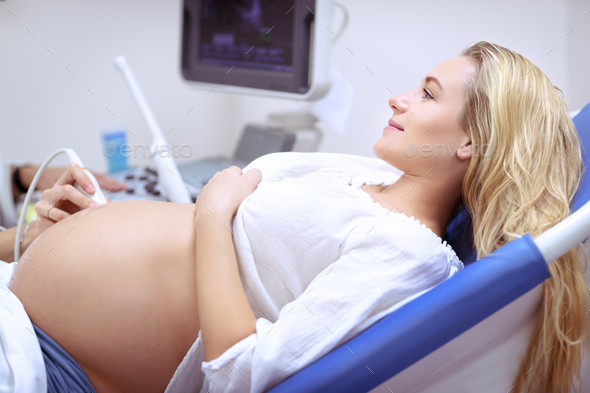 Pregnant woman on ultrasound - Stock Photo - Images