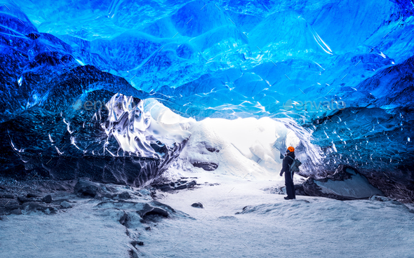 Traveler in ice cave - Stock Photo - Images