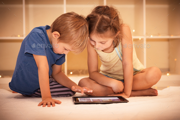 Happy children playing on the tablet - Stock Photo - Images