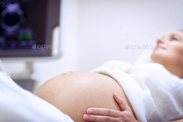 Pregnant woman doing ultrasound - Stock Photo - Images