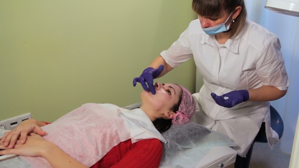 Beautician Gets a Soothing Cream on the Woman's Face Reddened Irritated Skin After Mesotherapy
