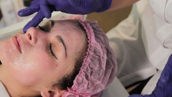 A Gloved Hand Gets a Soothing Cream on the Woman's Face Reddened, Irritated Skin After Mesotherapy