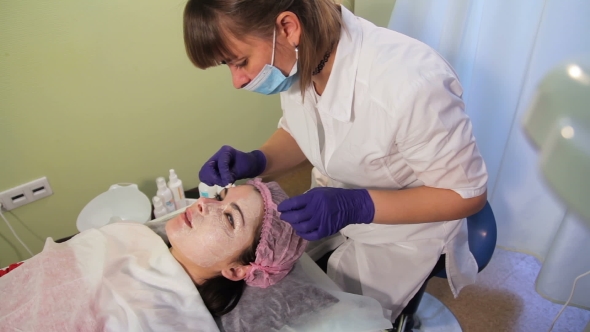 Beautician Removes the Mask From the Woman's Face Reddened, Irritated Skin After Mesotherapy
