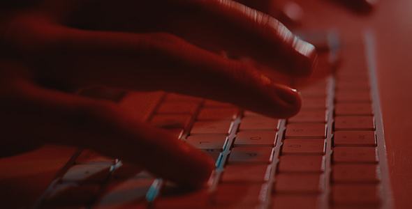 Typing on Keyboard in Red mood Lighting