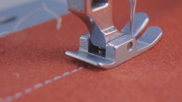 Sewing Needle of the Machine Sews Fabric alt