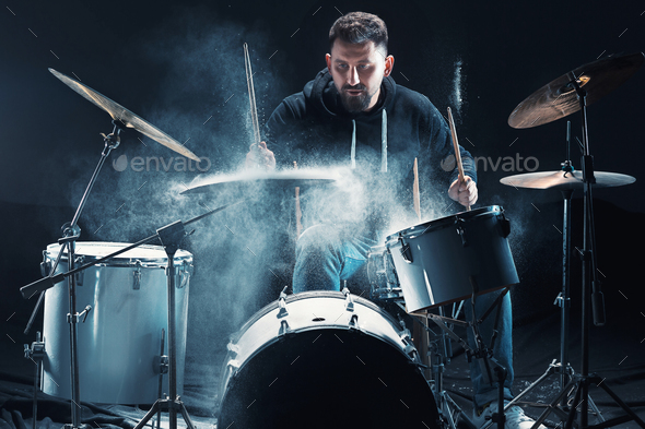 Drummer rehearsing on drums before rock concert. Man recording music on drum set in studio Stock Photo by master1305