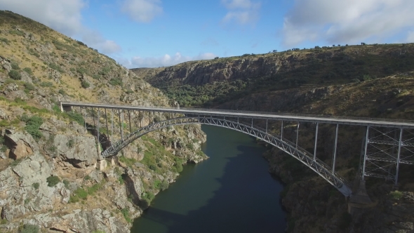 Aerial View of Iron Bridge Over Canyon with Tourist Walking