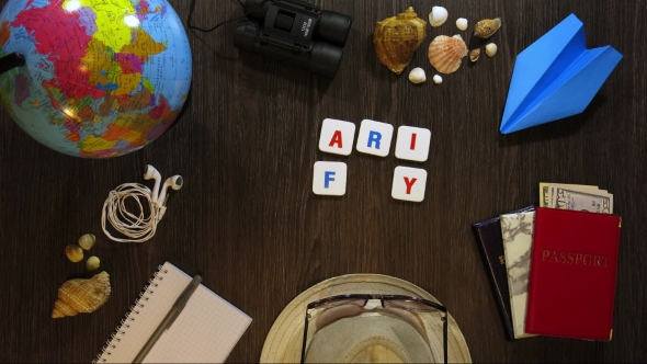 Phrase Family Trip on a Dark Wooden Background with Travel Accessories