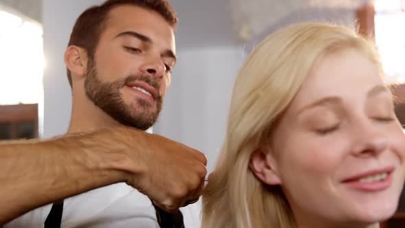Woman getting his hair trimmed with scissor alt