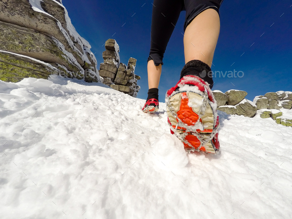 Running woman on winter trail, snow and white mountains - Stock Photo - Images