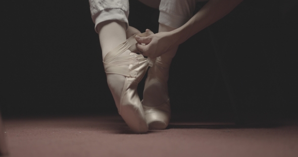 Ballet Dancer Putting on Her Ballet Shoes alt