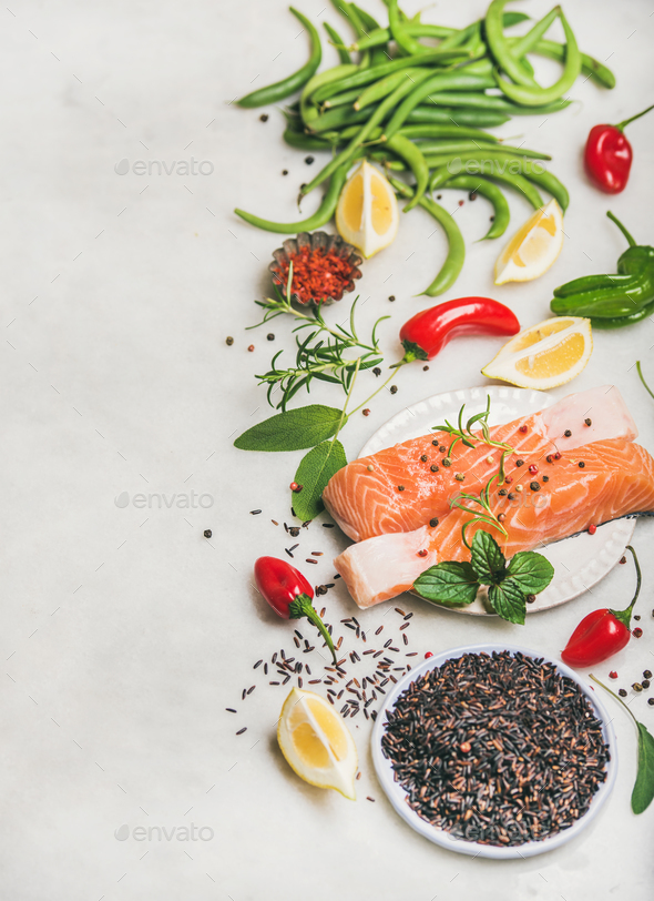 Raw salmon fillet steaks with vegetables, greens and rice - Stock Photo - Images