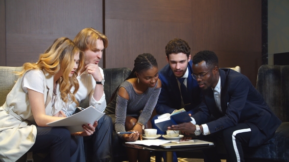 Confident Group Of Young Professionals In A Meeting. alt