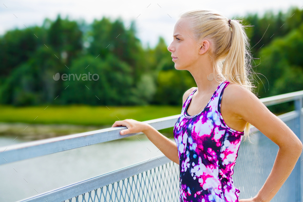 Thoughtful young woman rests after training - Stock Photo - Images