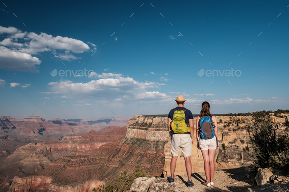 Tourists with backpack hiking at Grand Canyon Stock Photo by haveseen