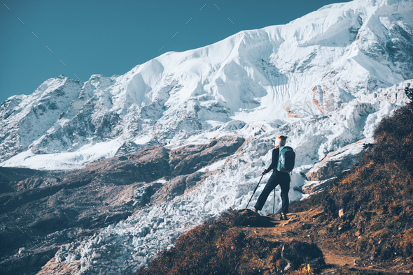 Woman with backpack on the mountain peak - Stock Photo - Images