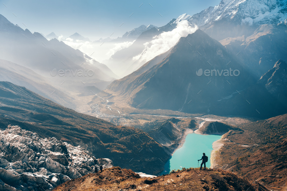 Woman looking on the lake and mountain valley - Stock Photo - Images