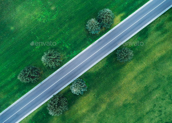 Aerial view of road through beautiful green field - Stock Photo - Images