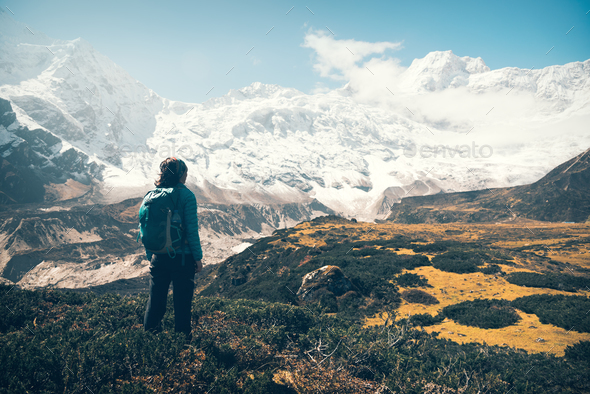 Woman with backpack looking on beautiful mountains - Stock Photo - Images