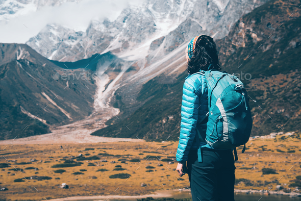 Woman with backpack looking on beautiful mountains - Stock Photo - Images