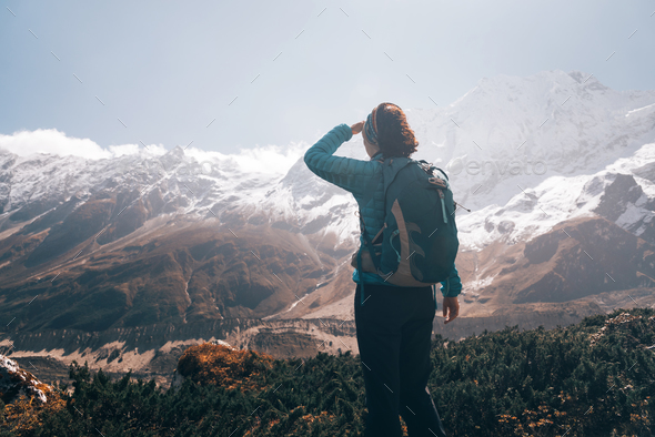 Woman with backpack looking on beautiful mountains - Stock Photo - Images