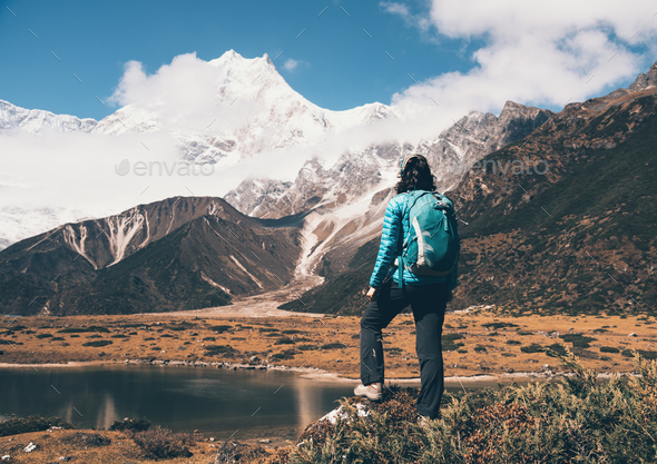 Standing young woman with backpack on the stone - Stock Photo - Images