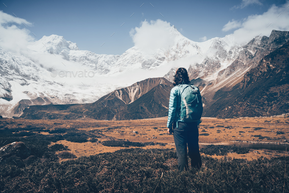 Woman with backpack looking on beautiful mountains - Stock Photo - Images