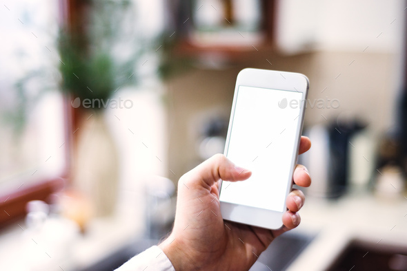 Mockup image of smartphone with blank white screen. Stock Photo by halfpoint