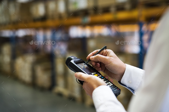 Warehouse worker or supervisor with barcode scanner.