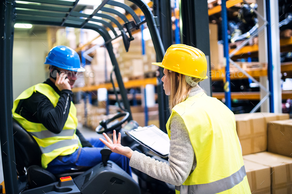 Young warehouse workers working together. - Stock Photo - Images