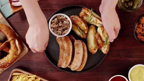 Putting Plate with Smoked Sasuages and Fried Potatoes Top View Pickled Cucumbers Bratwursts and alt