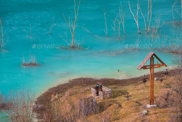 Church with cemetery under contaminated industrial water. Mining residuals that destroyed a village - Stock Photo - Images